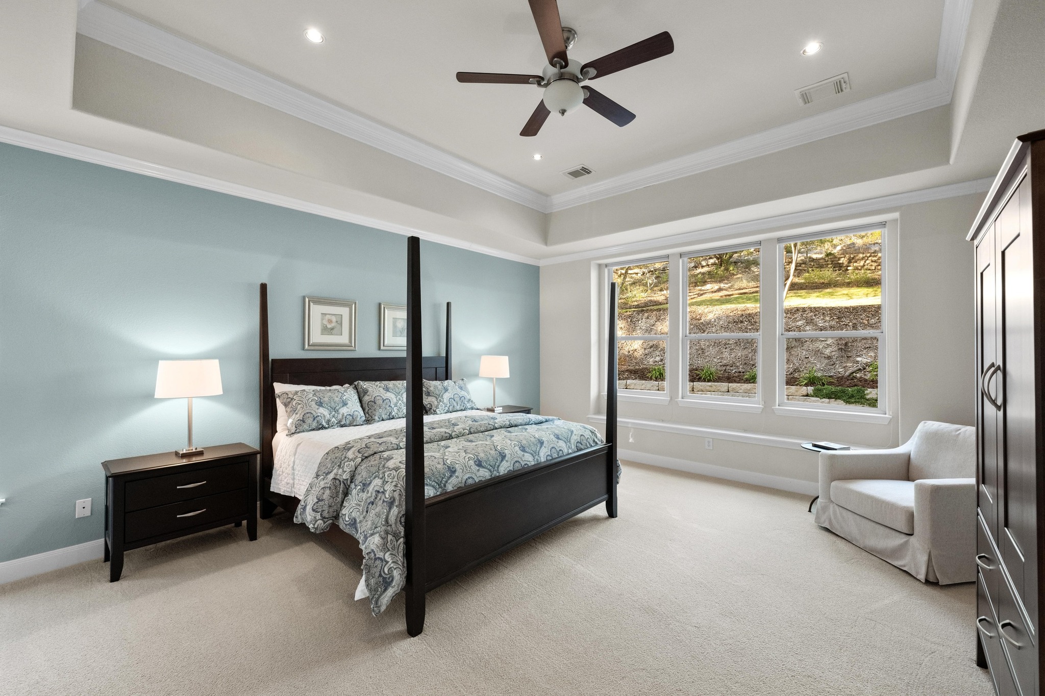 3713 Soledad Court Austin, TX 78732 - Photo 15 of 40 a bedroom with a bed couch and a large window