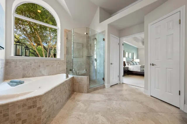 a bathroom with a tub and a shower