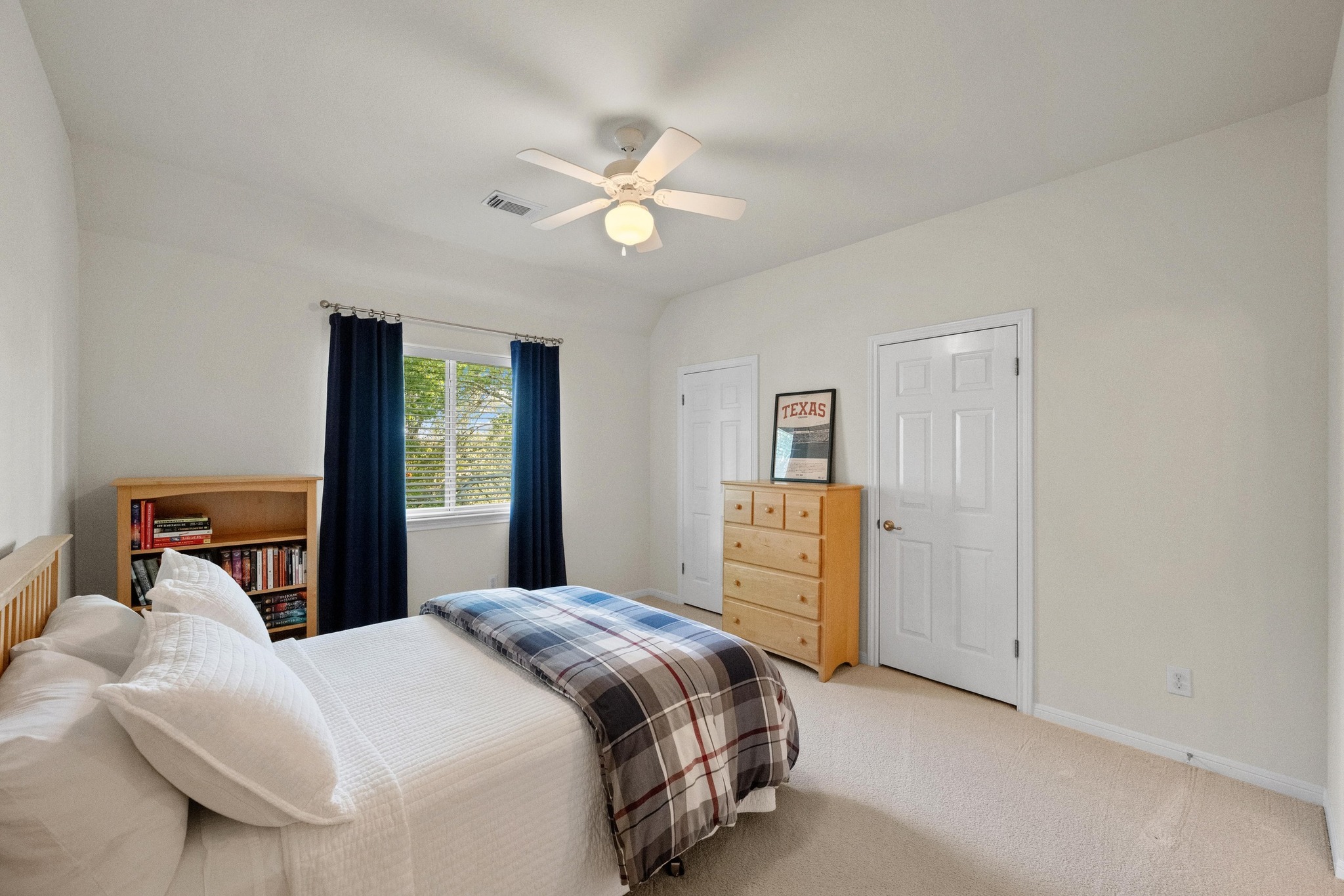 3713 Soledad Court Austin, TX 78732 - Photo 27 of 40 a bedroom with a bed and a chandelier