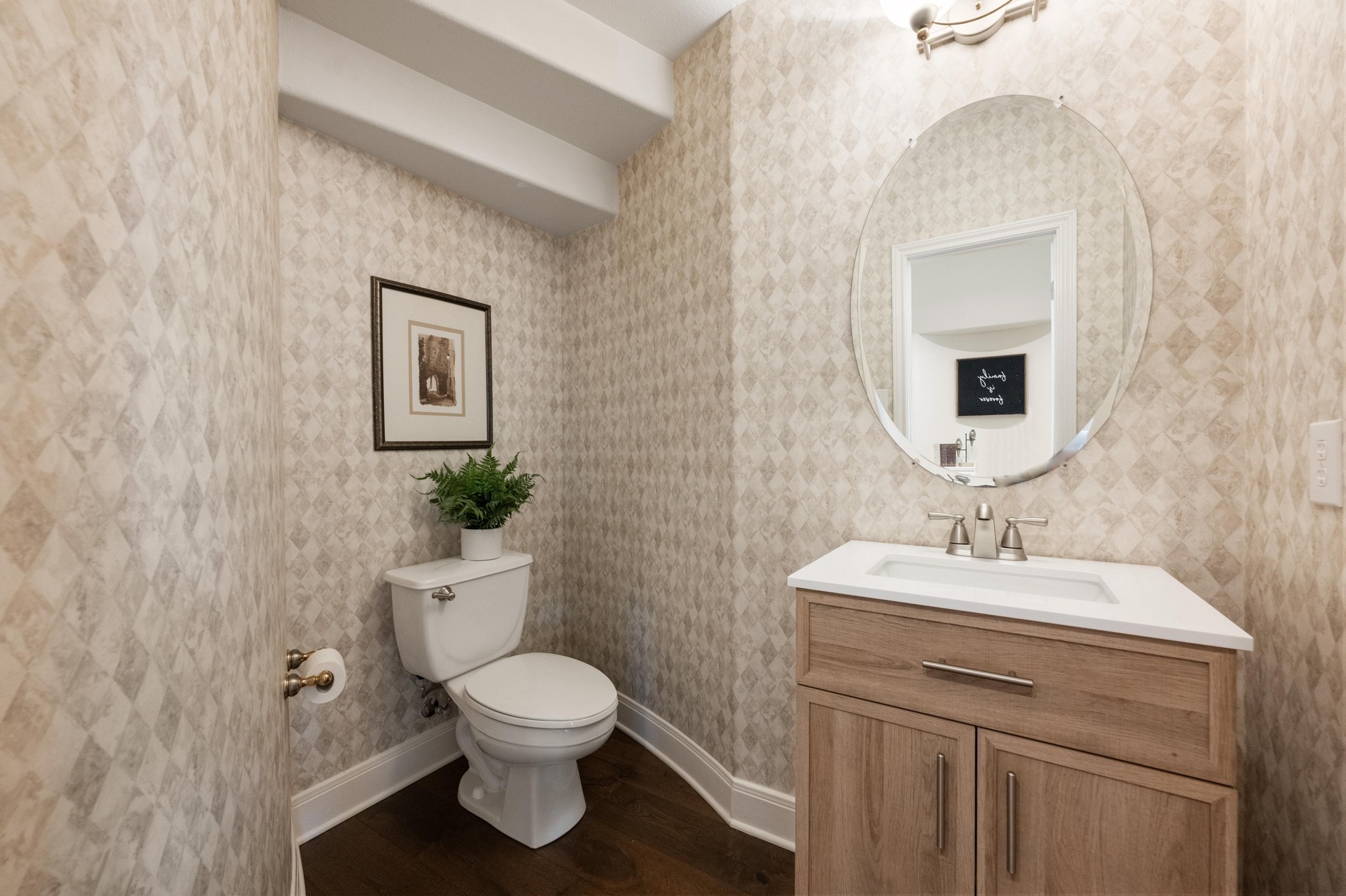 3713 Soledad Court Austin, TX 78732 - Photo 29 of 40 a bathroom with a toilet sink and mirror