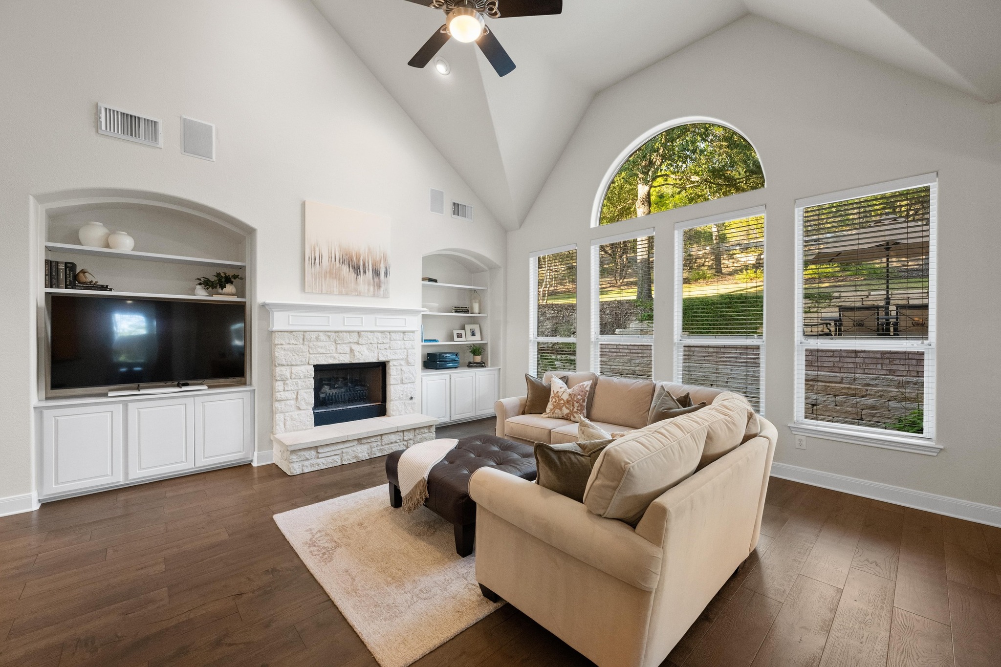3713 Soledad Court Austin, TX 78732 - Photo 7 of 40 a living room with furniture a flat screen tv and a fireplace