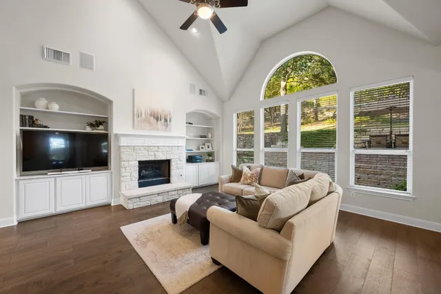 a living room with furniture a flat screen tv and a fireplace