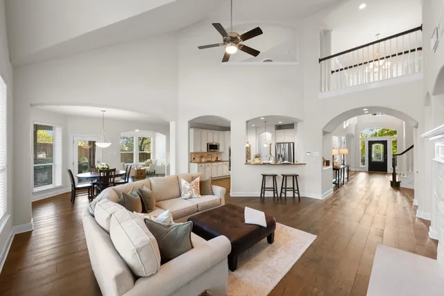 a living room with furniture a fireplace and wooden floor