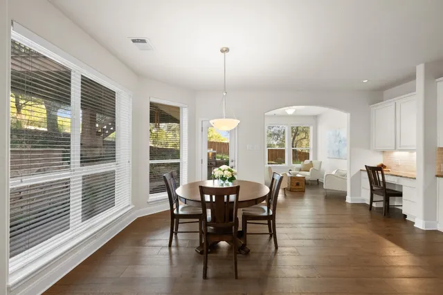 a view of a dining room with furniture window and wooden floor