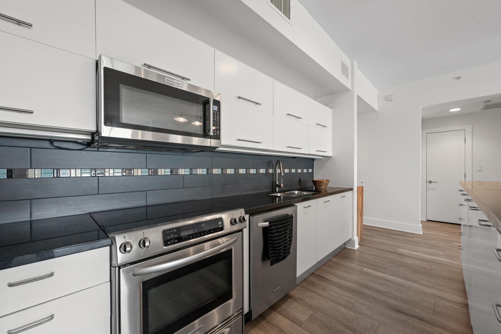 603 Davis Street, Unit 1002 Austin, TX 78701 - Photo 10 of 40 a kitchen with a stove oven and sink