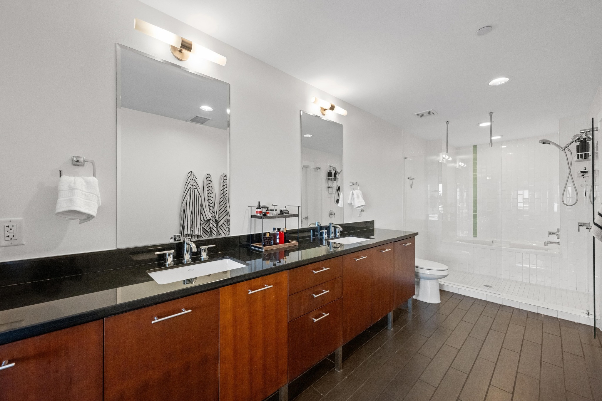 603 Davis Street, Unit 1002 Austin, TX 78701 - Photo 14 of 40 a large bathroom with a double vanity sink a large mirror and shower