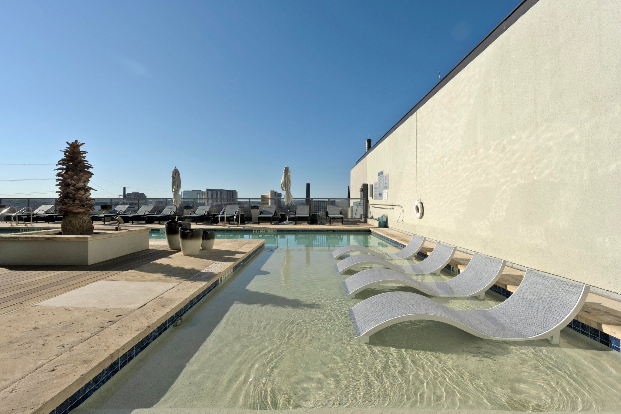 603 Davis Street, Unit 1002 Austin, TX 78701 - Photo 34 of 40 a view of a kitchen with kitchen island stainless steel appliances a sink and cabinets