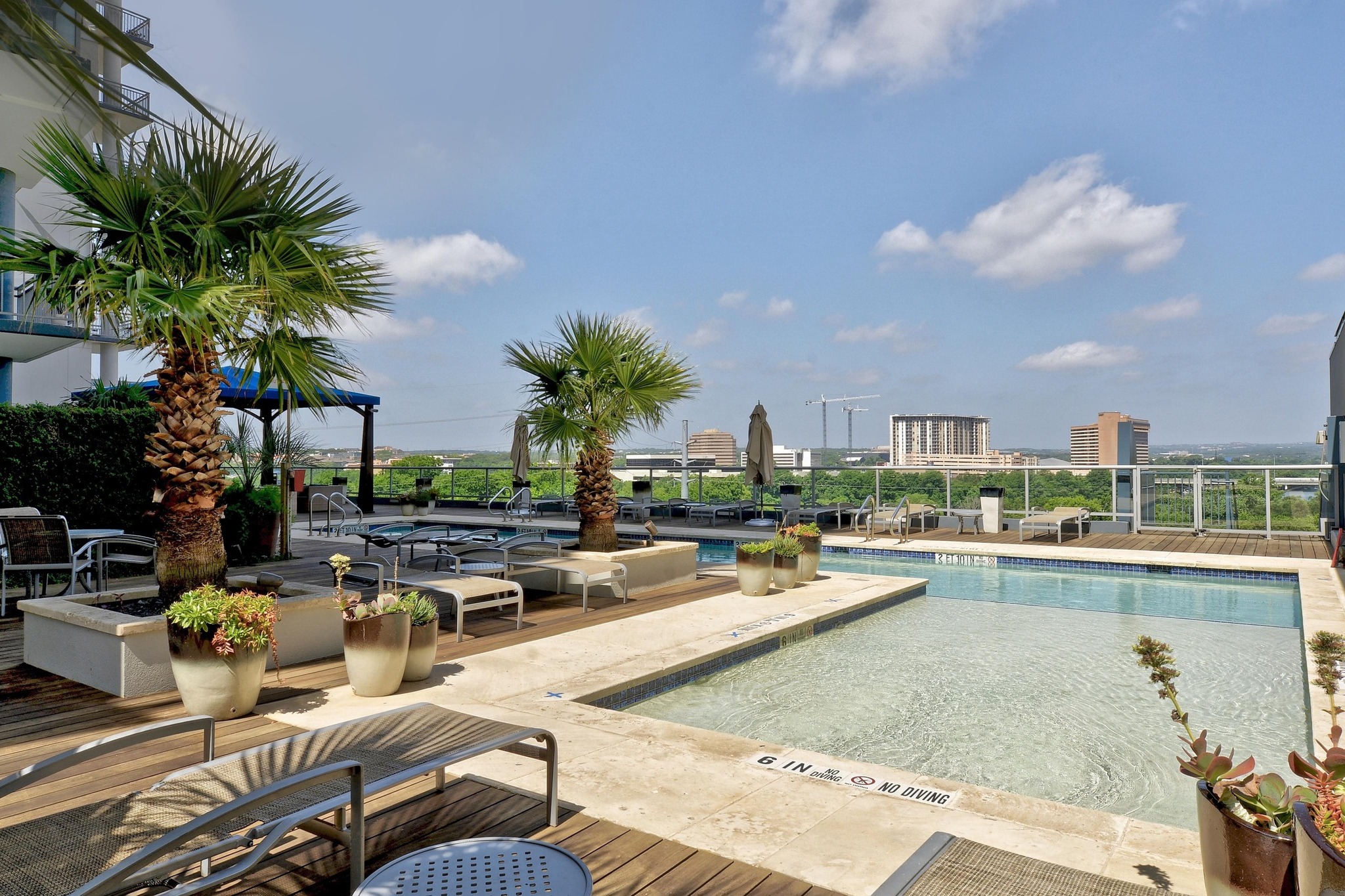603 Davis Street, Unit 1002 Austin, TX 78701 - Photo 35 of 40 a view of a swimming pool with outdoor seating and plants