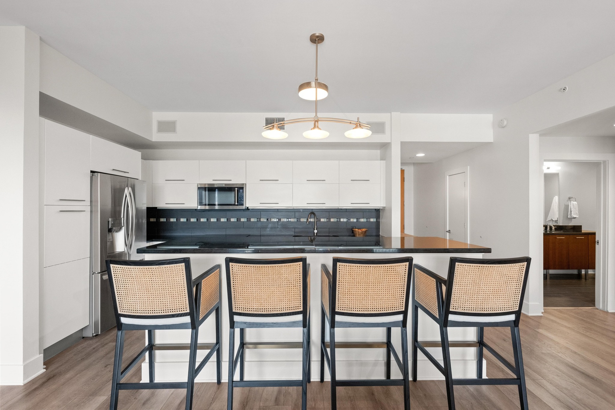 603 Davis Street, Unit 1002 Austin, TX 78701 - Photo 5 of 40 a kitchen with stainless steel appliances granite countertop a dining table chairs and chandelier