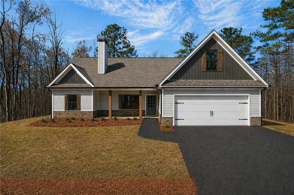 423 Relay Road Silver Creek, GA 30173 - Photo 7 of 48 a front view of a house with a yard and garage