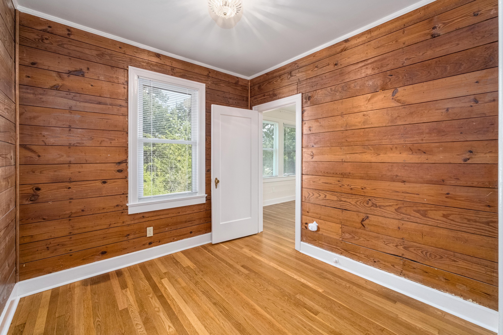 2012 Enfield Road, Unit B Austin, TX 78703 - Photo 9 of 20 Natural wood paneling and gleaming hardwood floors create a warm, inviting atmosphere in this versatile room.