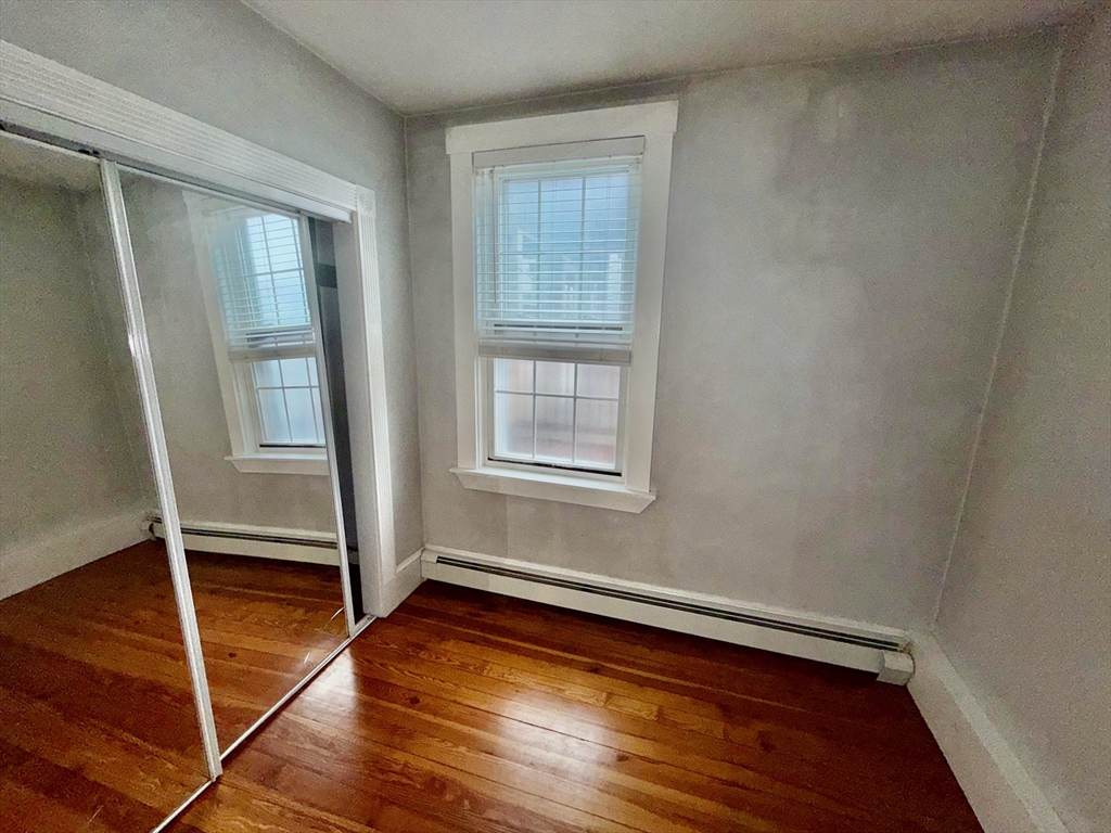 324 Chelsea Street, Unit 3 Boston, MA 02128 - Photo 13 of 20 a view of room with window and wooden floor