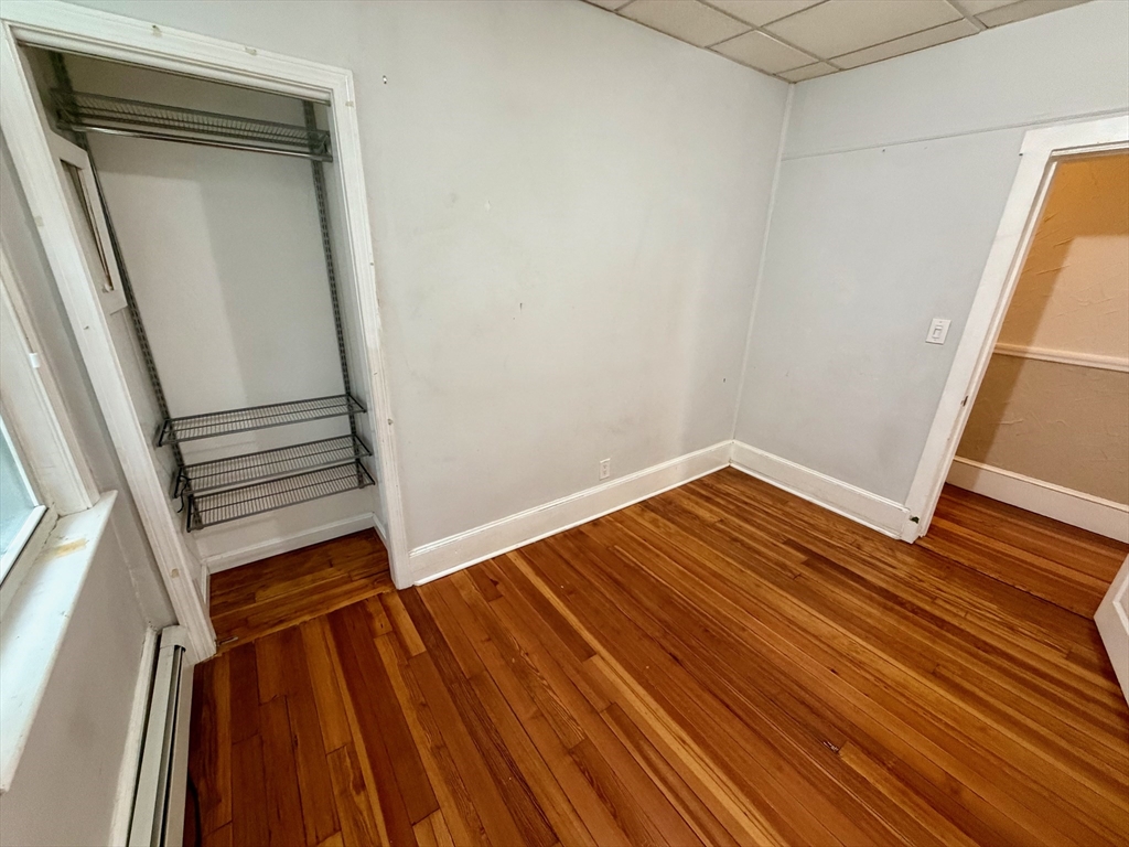 324 Chelsea Street, Unit 3 Boston, MA 02128 - Photo 14 of 20 a view of a room with wooden floor and staircase