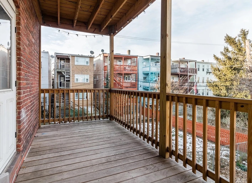 324 Chelsea Street, Unit 3 Boston, MA 02128 - Photo 2 of 20 a view of a balcony with wooden floor