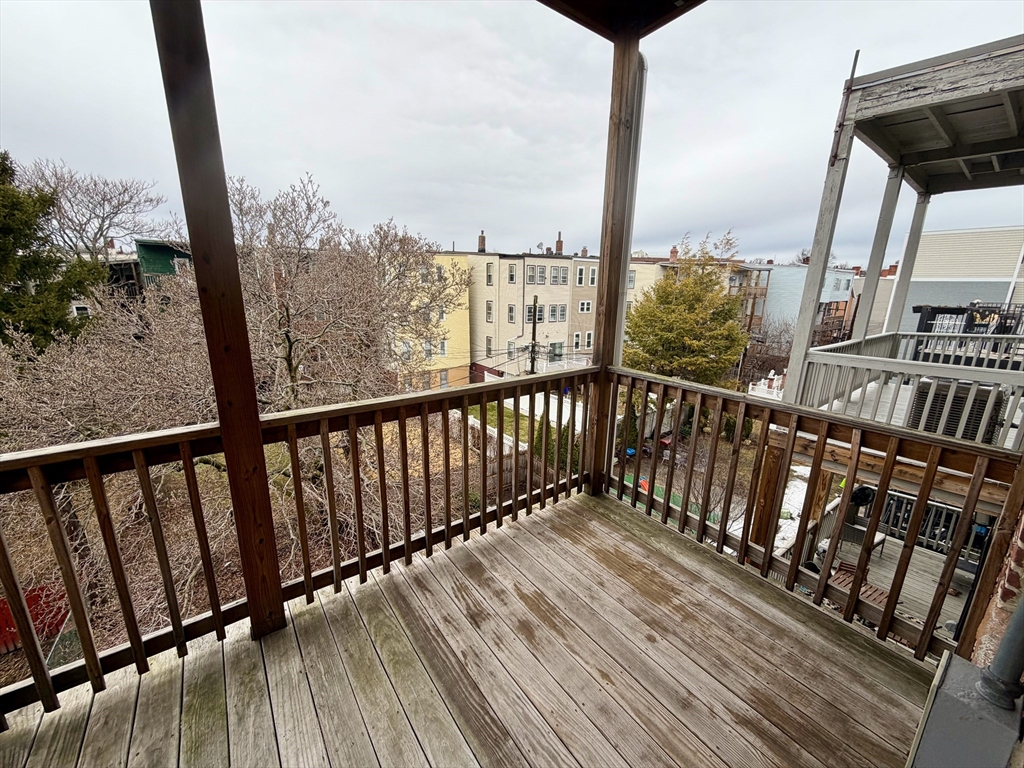 324 Chelsea Street, Unit 3 Boston, MA 02128 - Photo 9 of 20 a view of a balcony with wooden floor