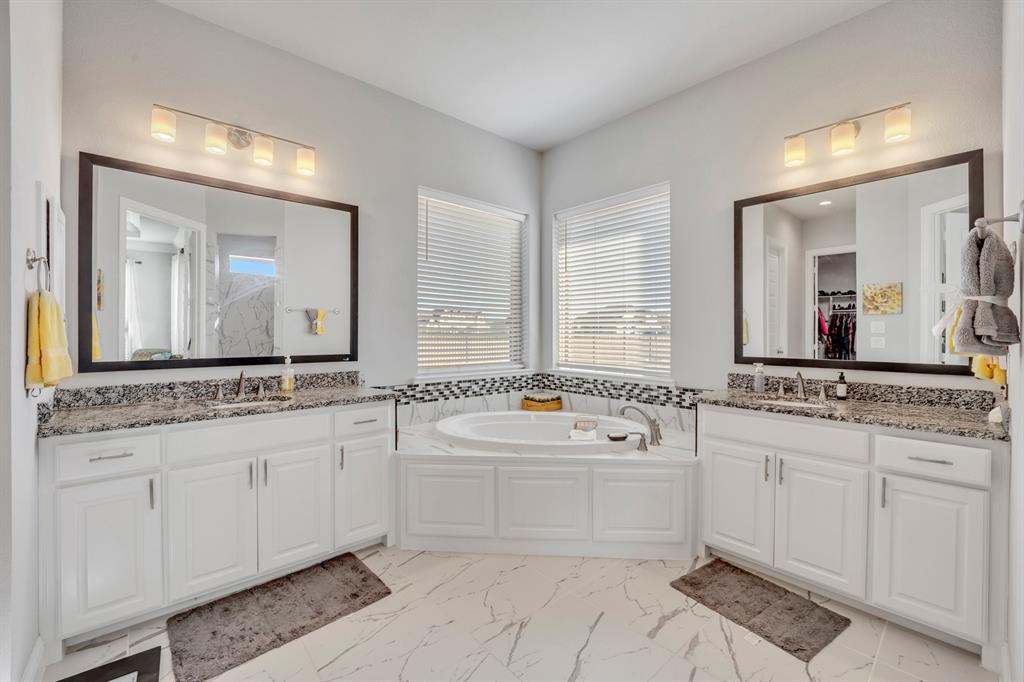 1340 Driftwood Lane Lucas, TX 75002 - Photo 18 of 23 a bathroom with a granite countertop double vanity sink a mirror and a bathtub