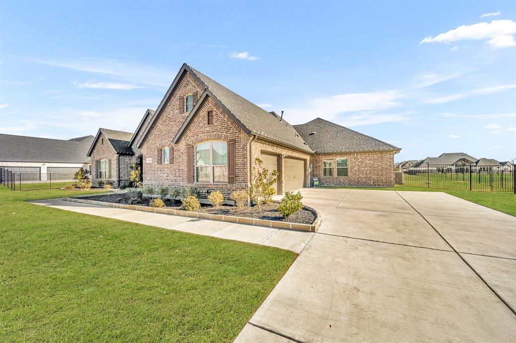 1340 Driftwood Lane Lucas, TX 75002 - Photo 2 of 23 a front view of a house with yard and green space