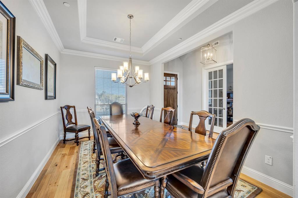 1340 Driftwood Lane Lucas, TX 75002 - Photo 6 of 23 a view of a dining room with furniture a chandelier and wooden floor