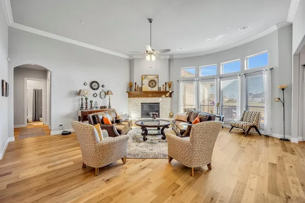 a living room with fireplace furniture and a large window