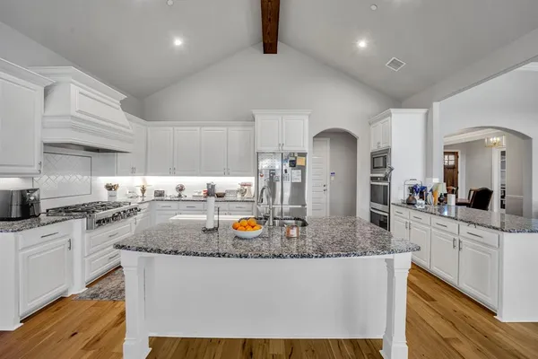 a kitchen with sink stove and refrigerator