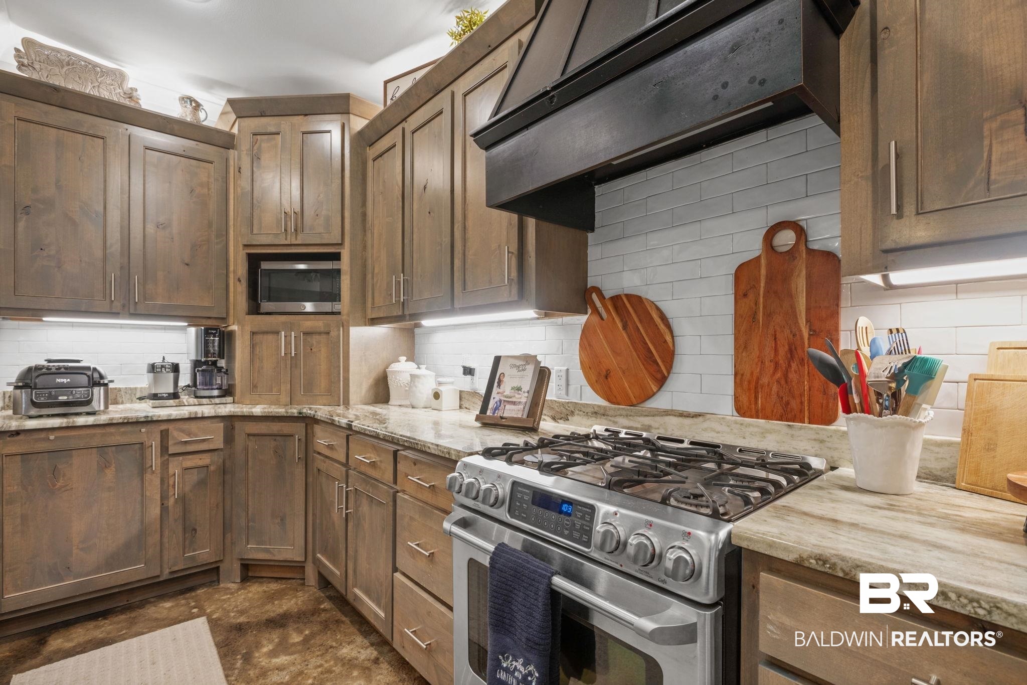 4331 Hamilton Oaks Lane Mobile, AL 36695 - Photo 9 of 38 Kitchen featuring stainless steel appliances, under cabinet range hood, tasteful backsplash, and light stone countertops
