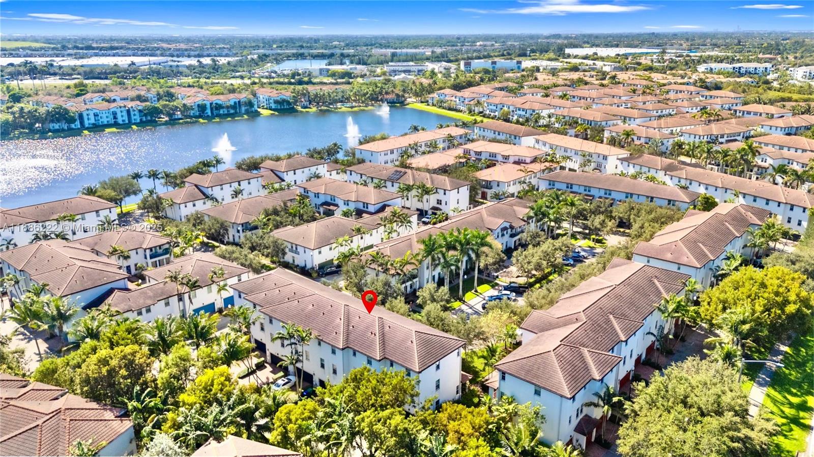 an aerial view of lake and residential houses with outdoor space