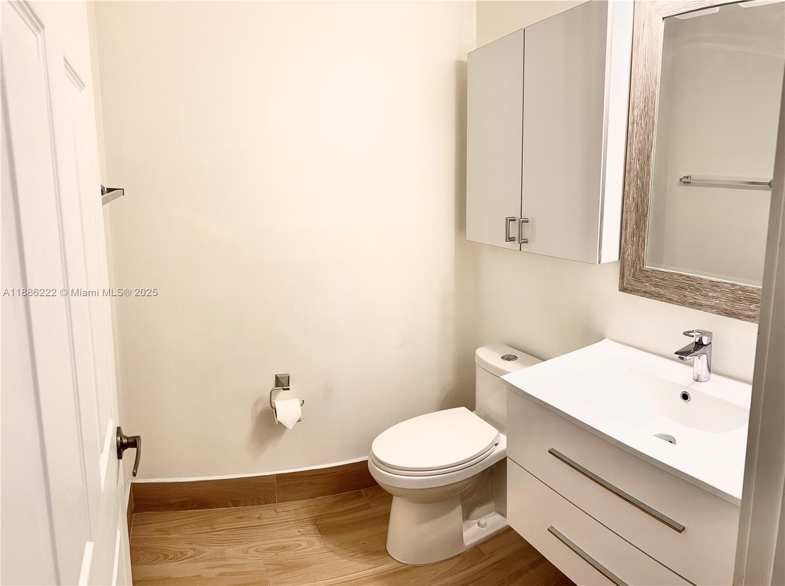 2549 Southwest 118th Way, Unit 302 Miramar, FL 33025 - Photo 13 of 43 a bathroom with a white toilet sitting next to a white sink and vanity