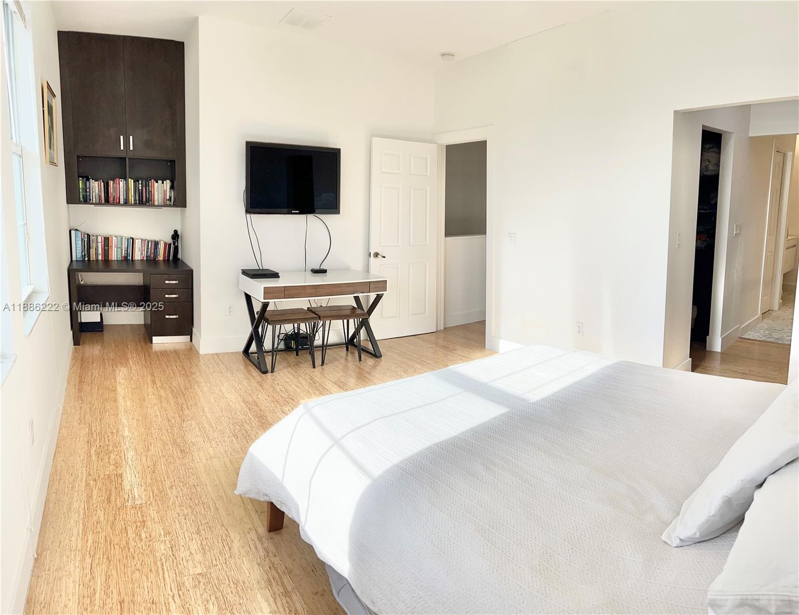 2549 Southwest 118th Way, Unit 302 Miramar, FL 33025 - Photo 14 of 43 a bedroom with a bed and a flat screen tv