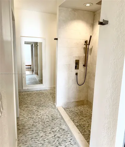 a bathroom with a glass shower door