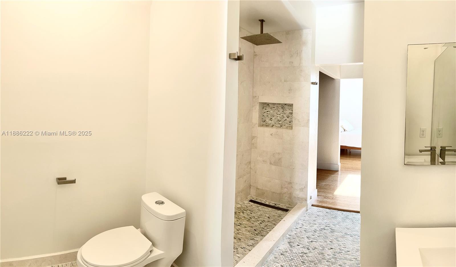 2549 Southwest 118th Way, Unit 302 Miramar, FL 33025 - Photo 17 of 43 a bathroom with a toilet and a shower