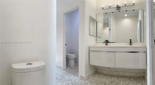 a bathroom with a sink toilet and mirror