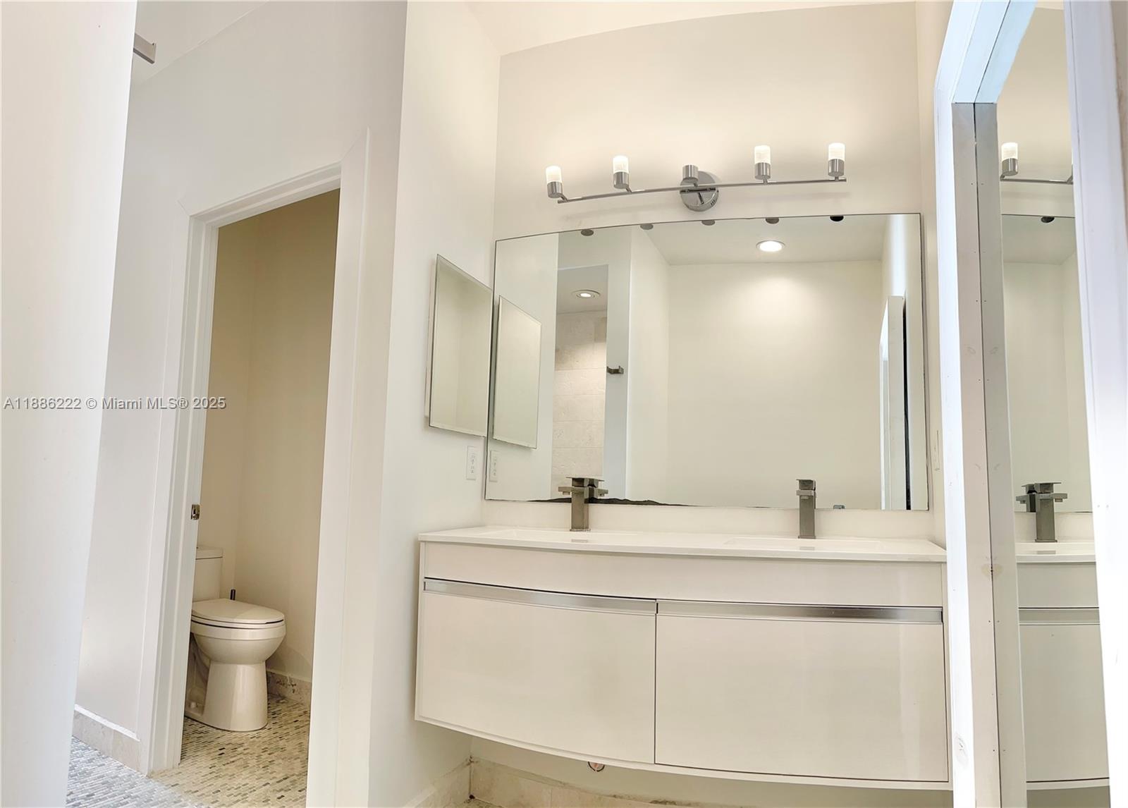 2549 Southwest 118th Way, Unit 302 Miramar, FL 33025 - Photo 20 of 43 a bathroom with a sink toilet a mirror and shower