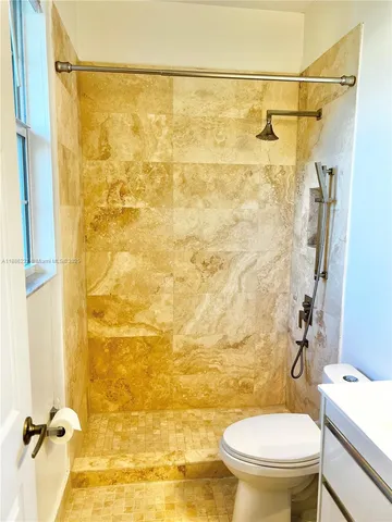 a bathroom with a toilet and a shower