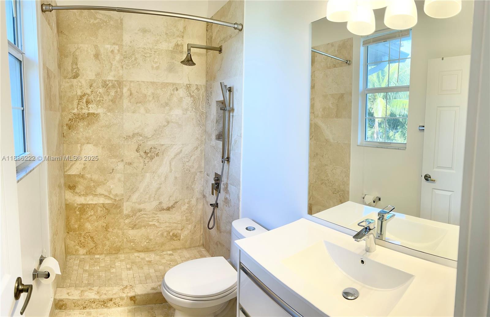 2549 Southwest 118th Way, Unit 302 Miramar, FL 33025 - Photo 28 of 43 a bathroom with a sink a toilet and shower