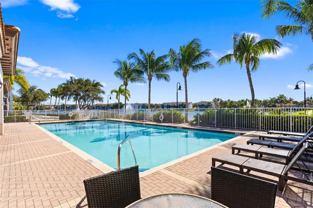 a view of a swimming pool with a lounge chair