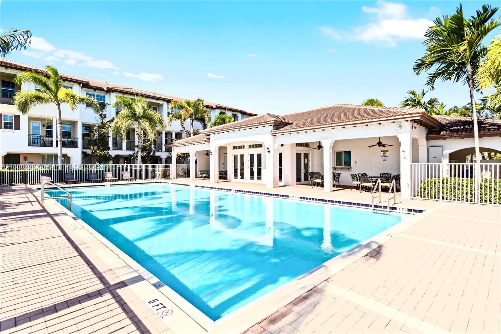 2549 Southwest 118th Way, Unit 302 Miramar, FL 33025 - Photo 39 of 43 swimming pool view with outdoor seating