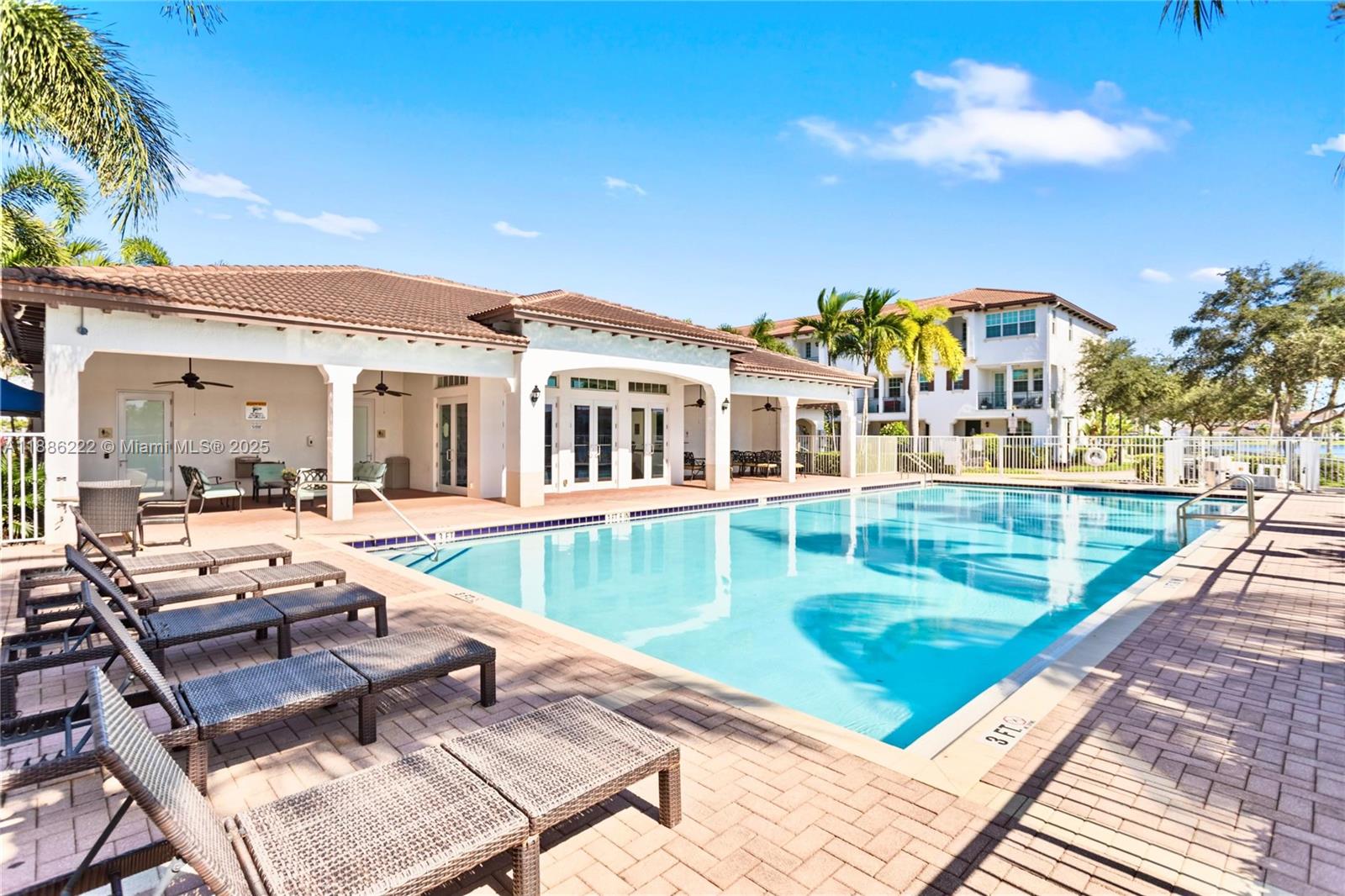 2549 Southwest 118th Way, Unit 302 Miramar, FL 33025 - Photo 40 of 43 a view of a patio with couches table and chairs with wooden floor and fence