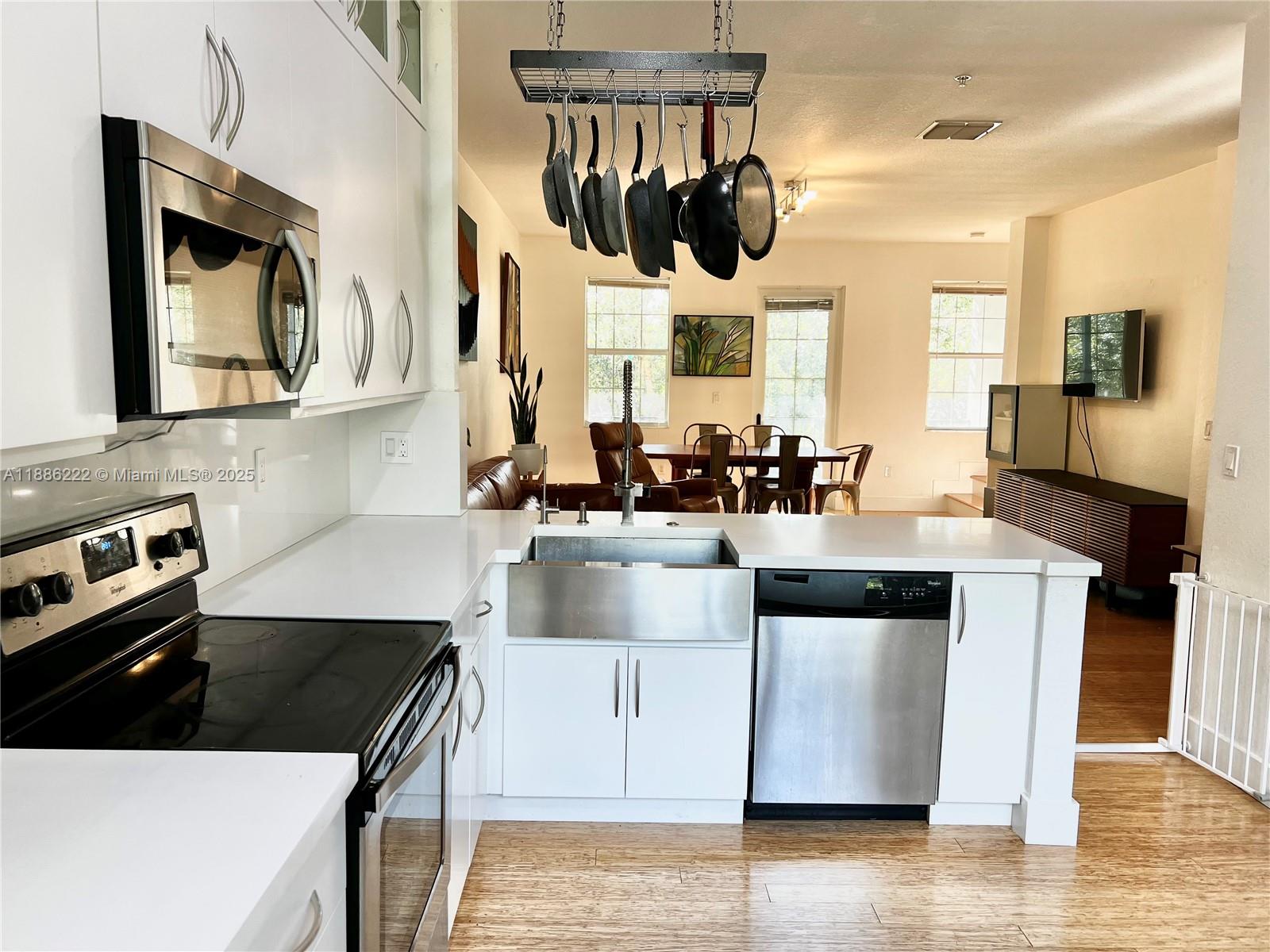 2549 Southwest 118th Way, Unit 302 Miramar, FL 33025 - Photo 6 of 43 a kitchen with a stove and a microwave