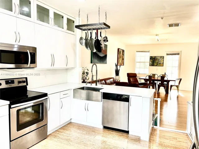 a kitchen with a sink stove and microwave