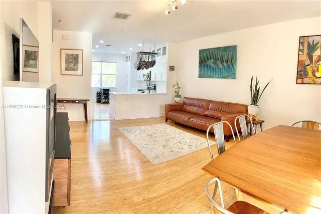 a living room with furniture and a wooden floor