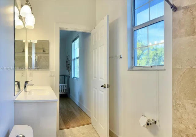 a bathroom with a sink a mirror and a shower