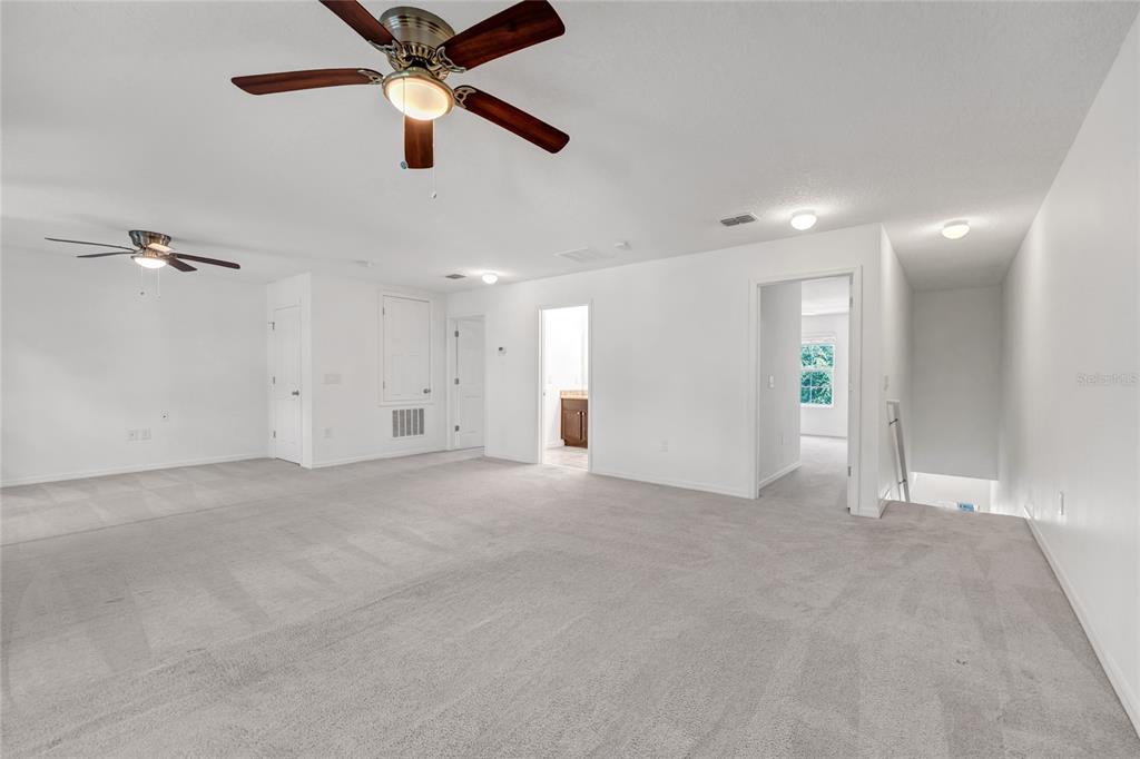 4824 Poolside Drive St. Cloud, FL 34769 - Photo 19 of 29 an empty room with ceiling fan and window
