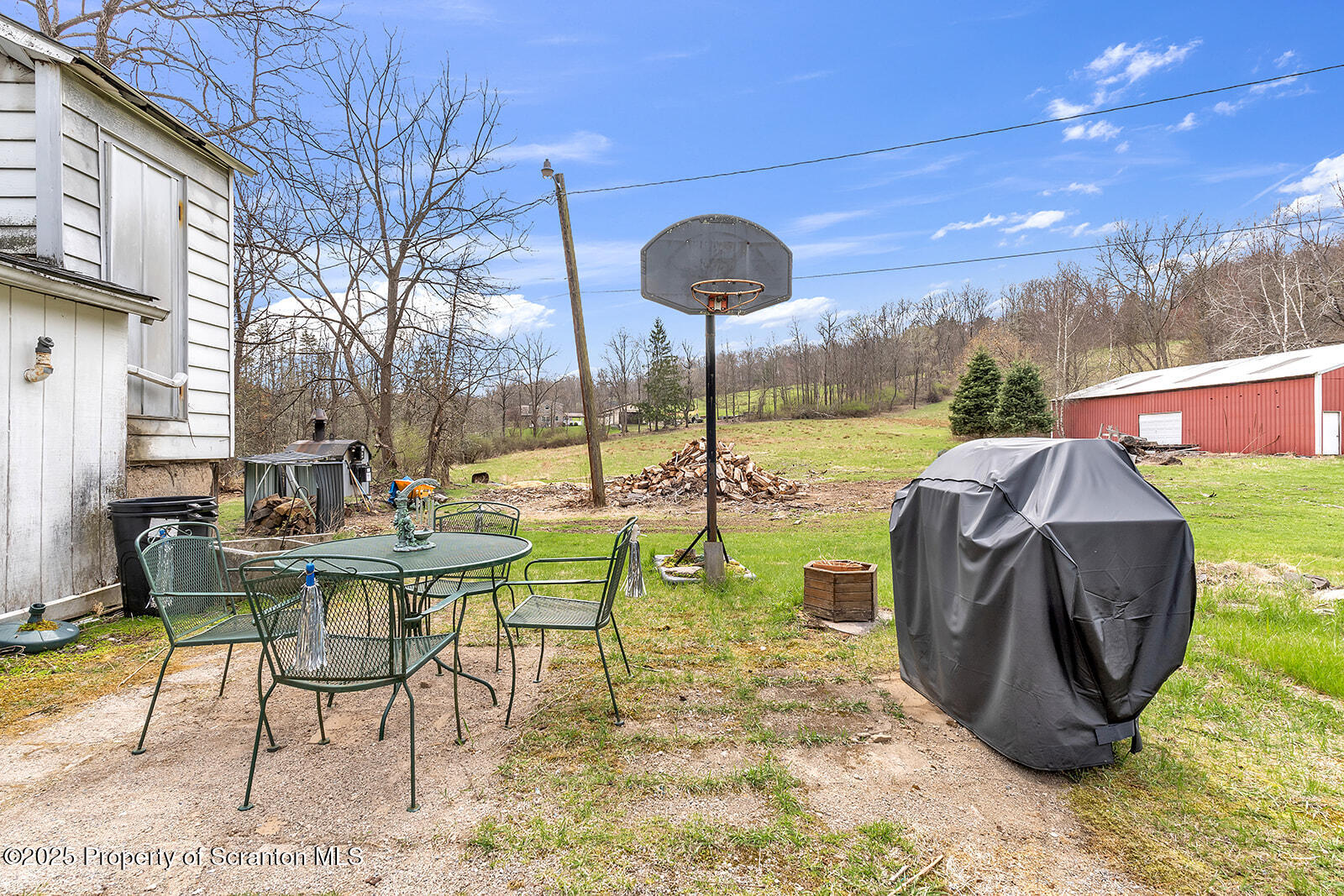 1079 Sutton Creek Road Dallas, PA 18612 - Photo 17 of 64 a view of a patio with table and chairs potted plants with wooden floor and fence