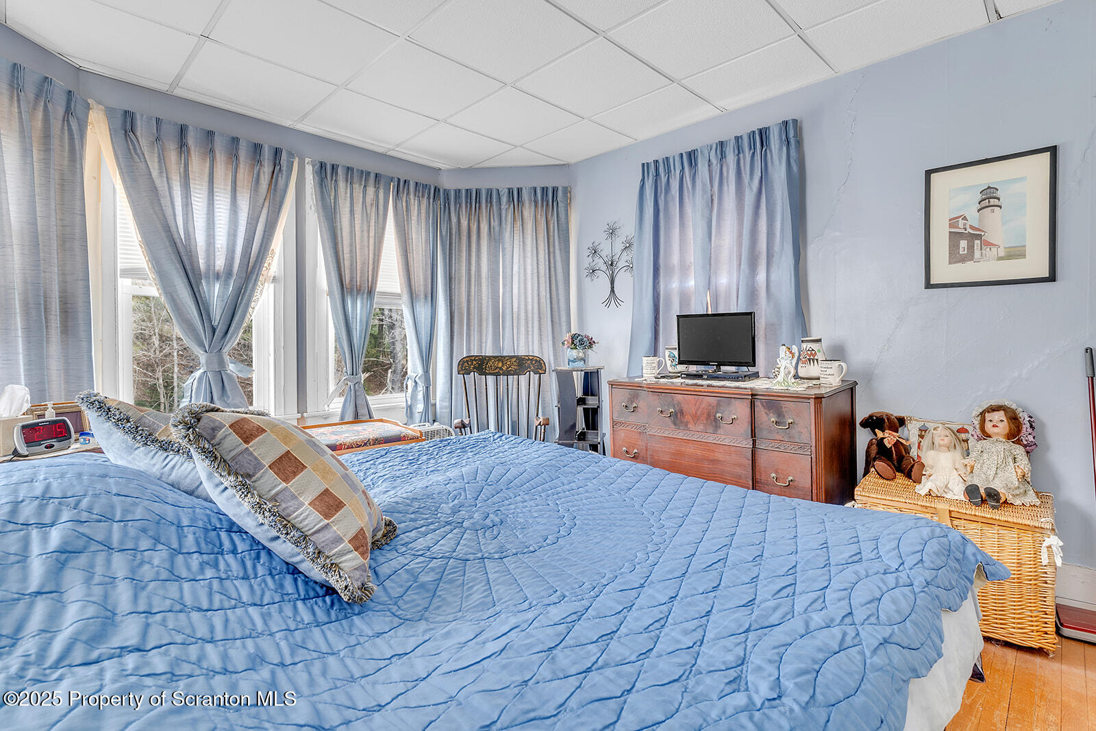 1079 Sutton Creek Road Dallas, PA 18612 - Photo 24 of 64 a bedroom with a bed and large windows