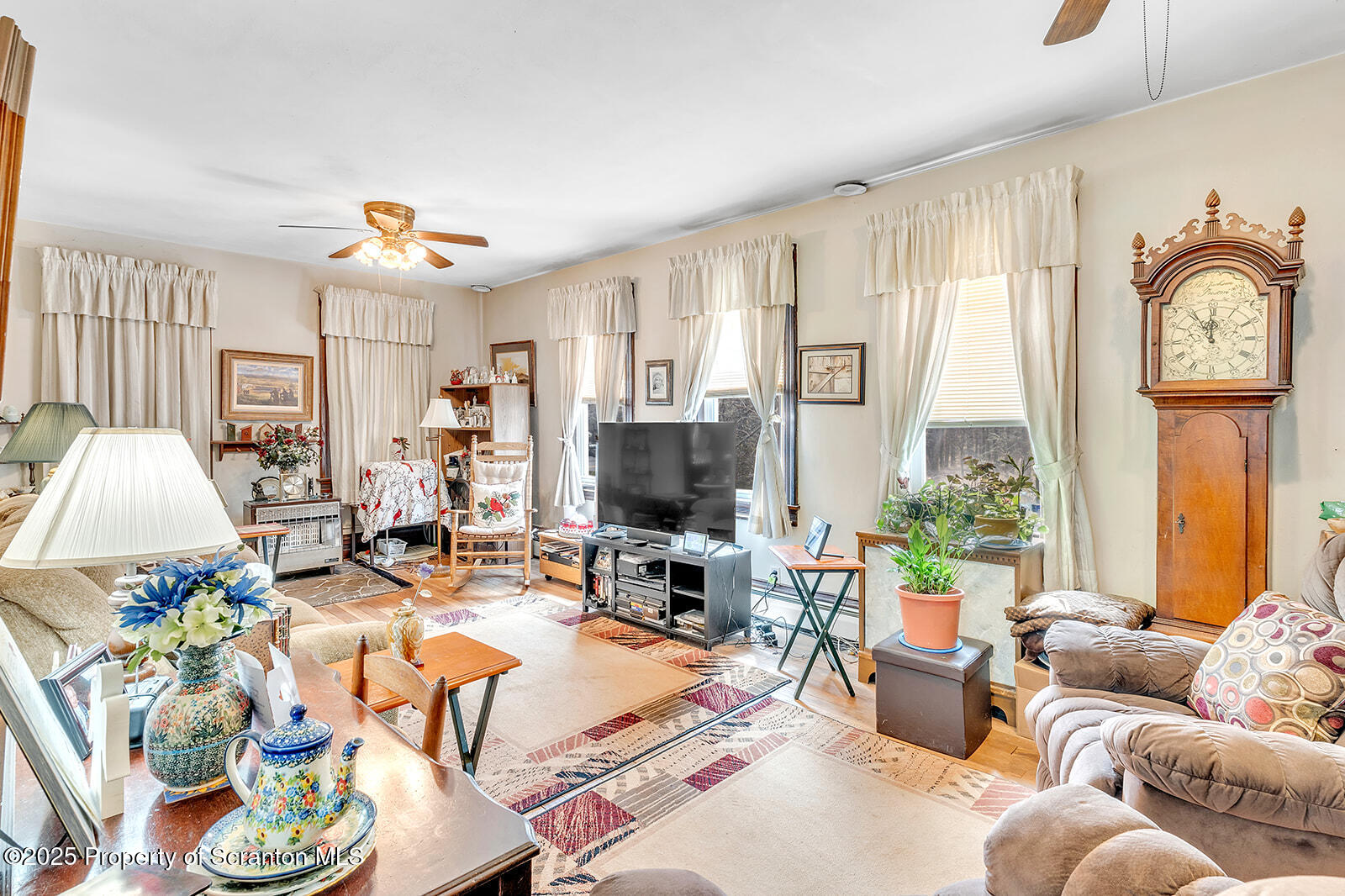 1079 Sutton Creek Road Dallas, PA 18612 - Photo 50 of 64 a living room with furniture a fireplace and a flat screen tv