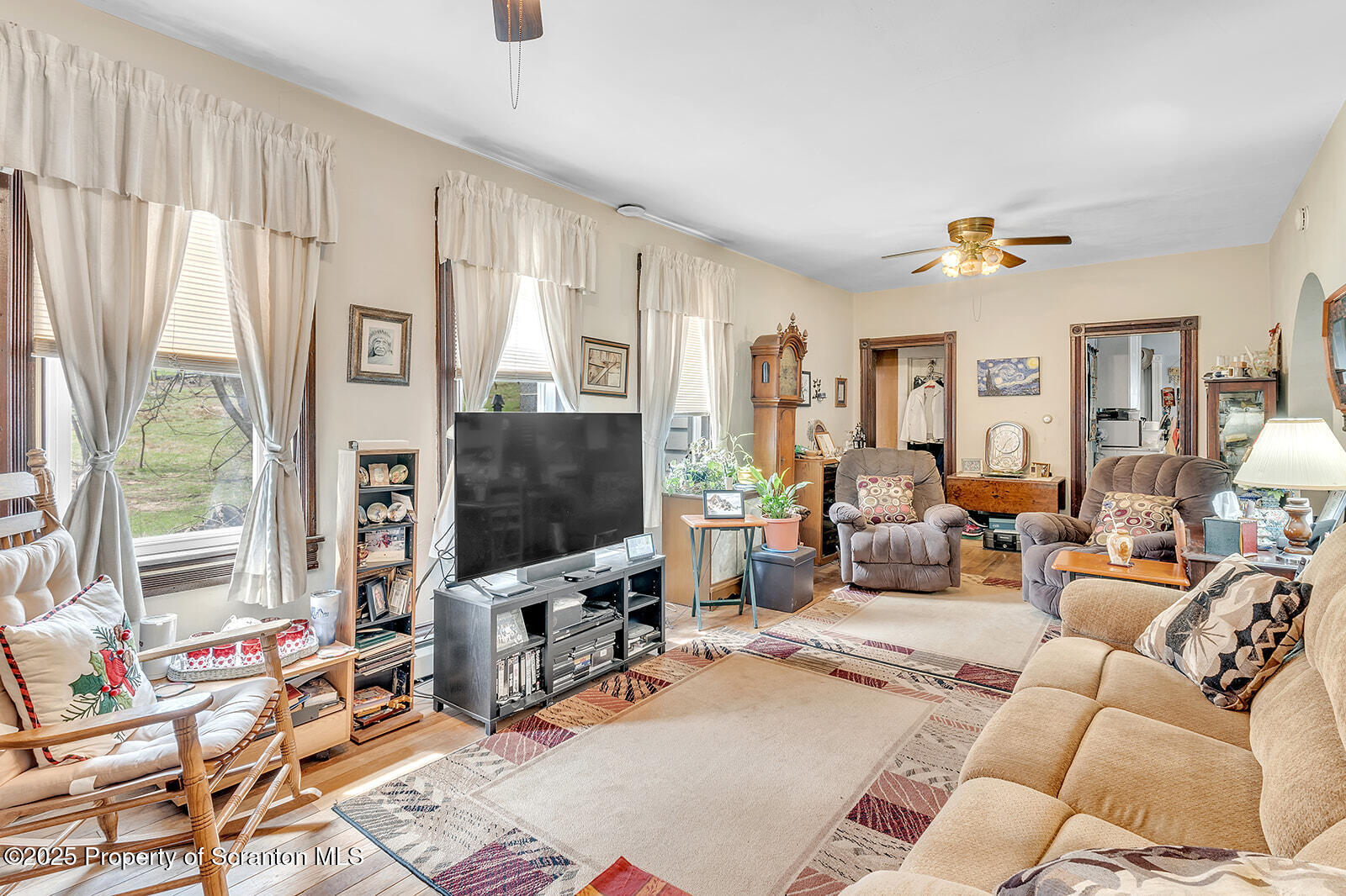 1079 Sutton Creek Road Dallas, PA 18612 - Photo 51 of 64 a living room with furniture a flat screen tv and a window