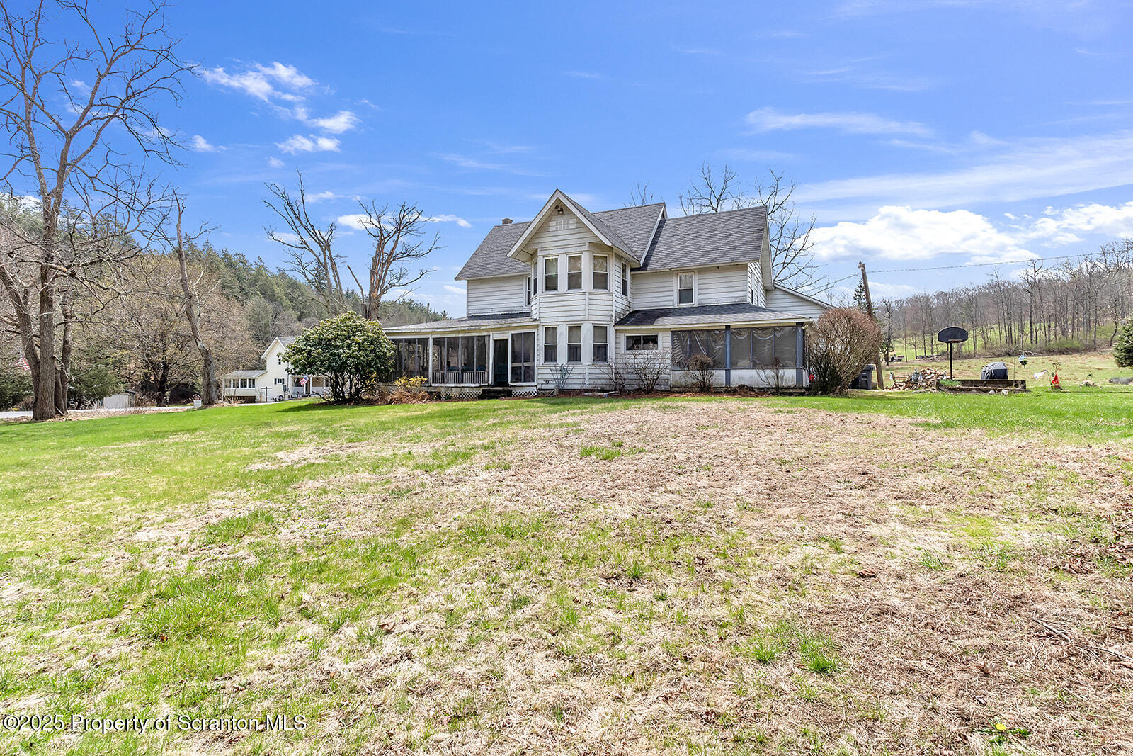 1079 Sutton Creek Road Dallas, PA 18612 - Photo 57 of 64 a view of a house with a big yard and large trees