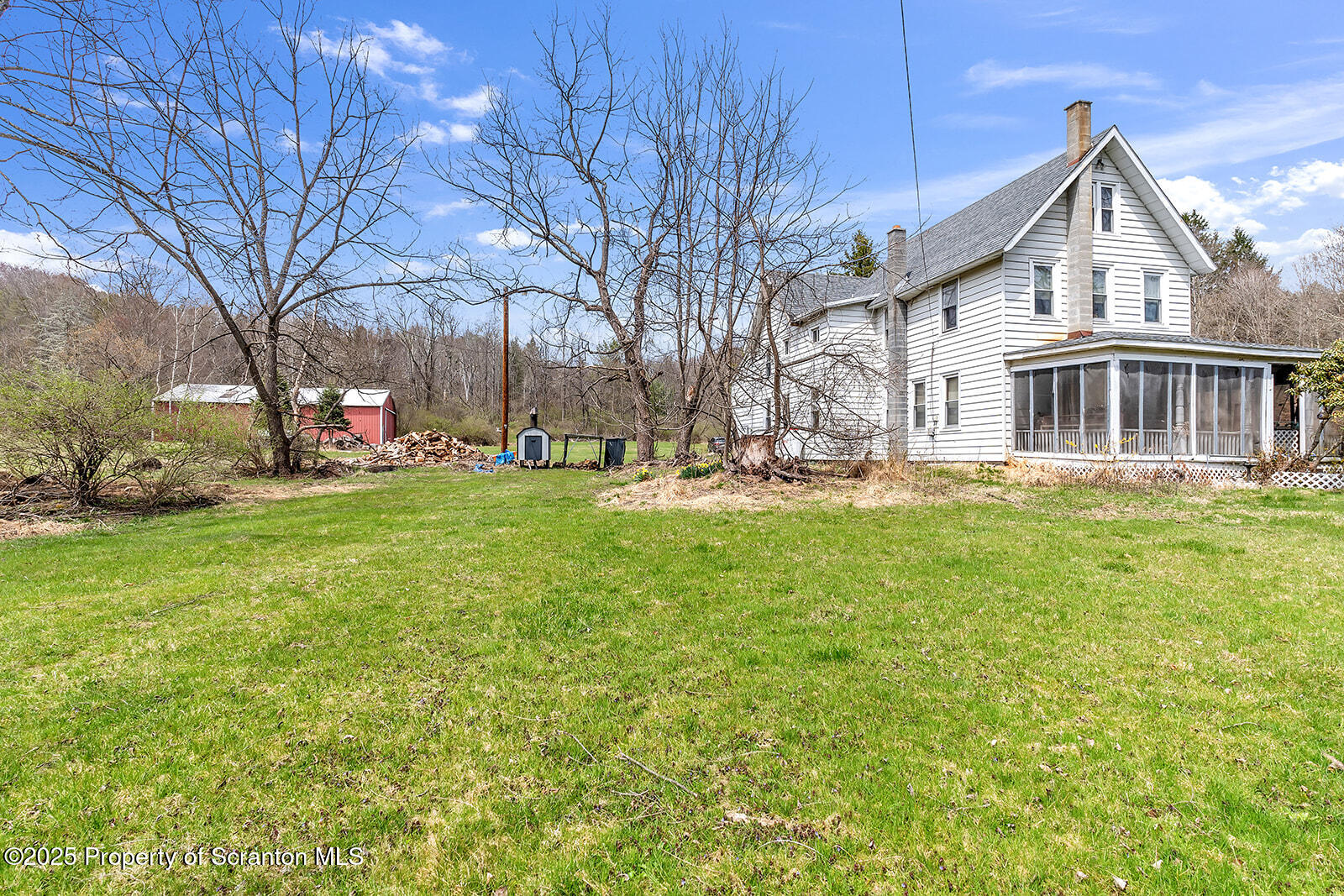 1079 Sutton Creek Road Dallas, PA 18612 - Photo 60 of 64 a front view of a house with a yard and trees