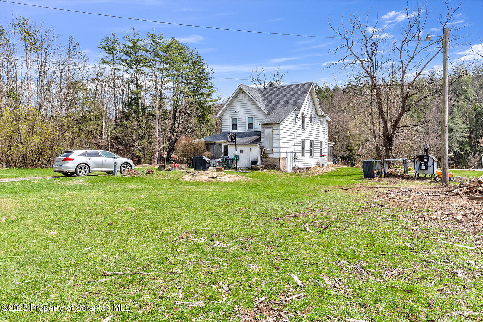 1079 Sutton Creek Road Dallas, PA 18612 - Photo 63 of 64 a view of a house with a yard and large trees