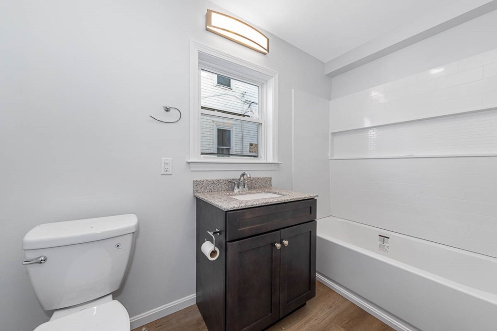 40 Everett Avenue Somerville, MA 02145 - Photo 12 of 21 a bathroom with a sink a toilet and shower